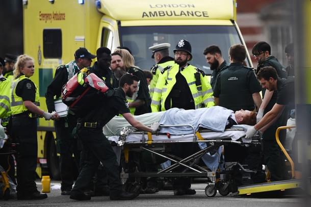 A member of the public is treated by emergency services near Westminster Bridge and the Houses of Parliament after the terror attack. (Carl Court/GettyImages)  